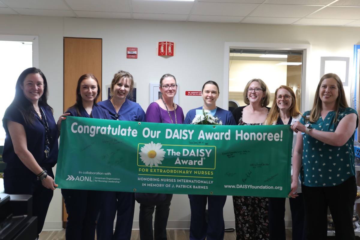 DAISY committee holding banner